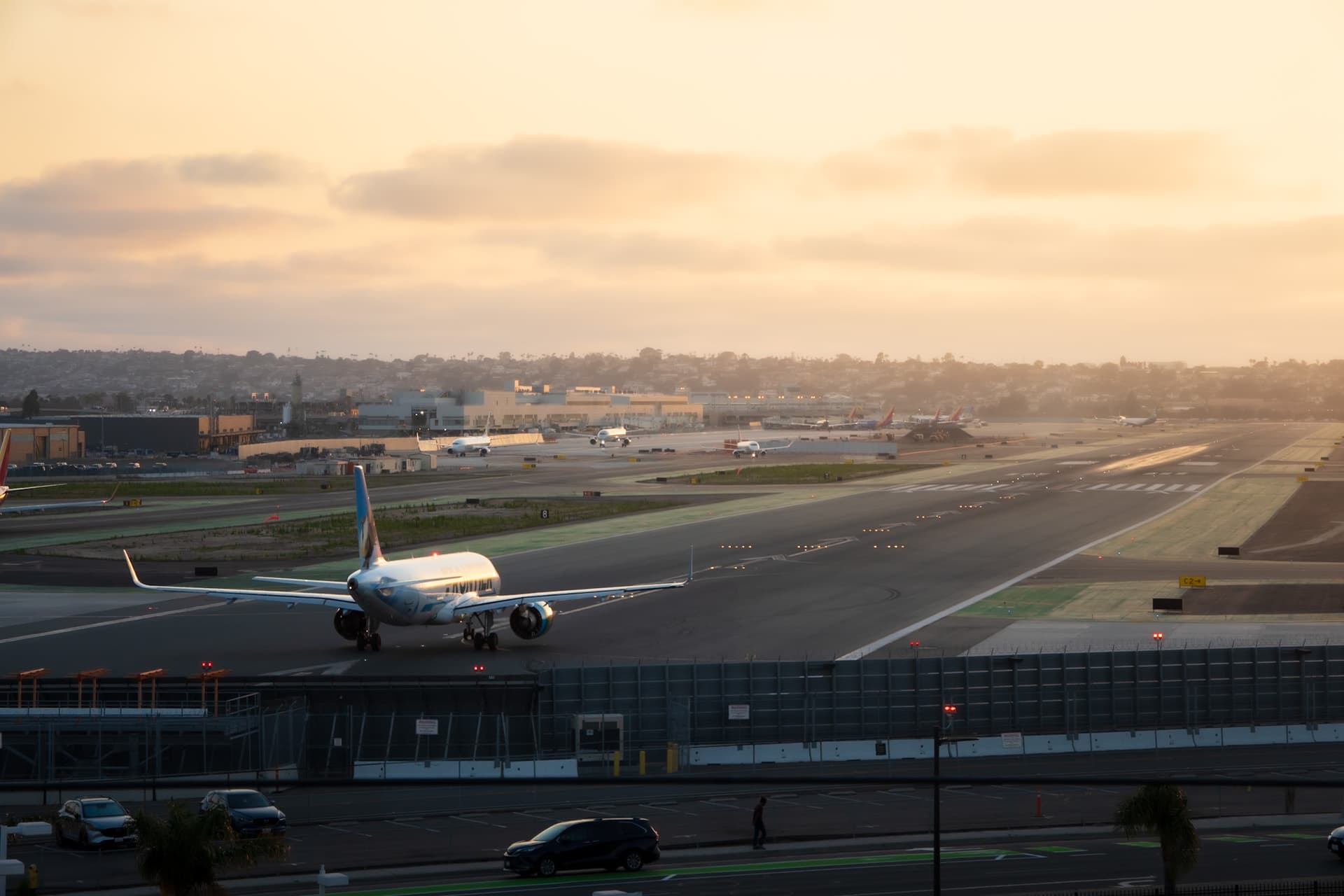Airplane taking off into the sunset at San Diego Airport